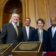 Slave Labor Task Force stands behind newly unveiled plaques.